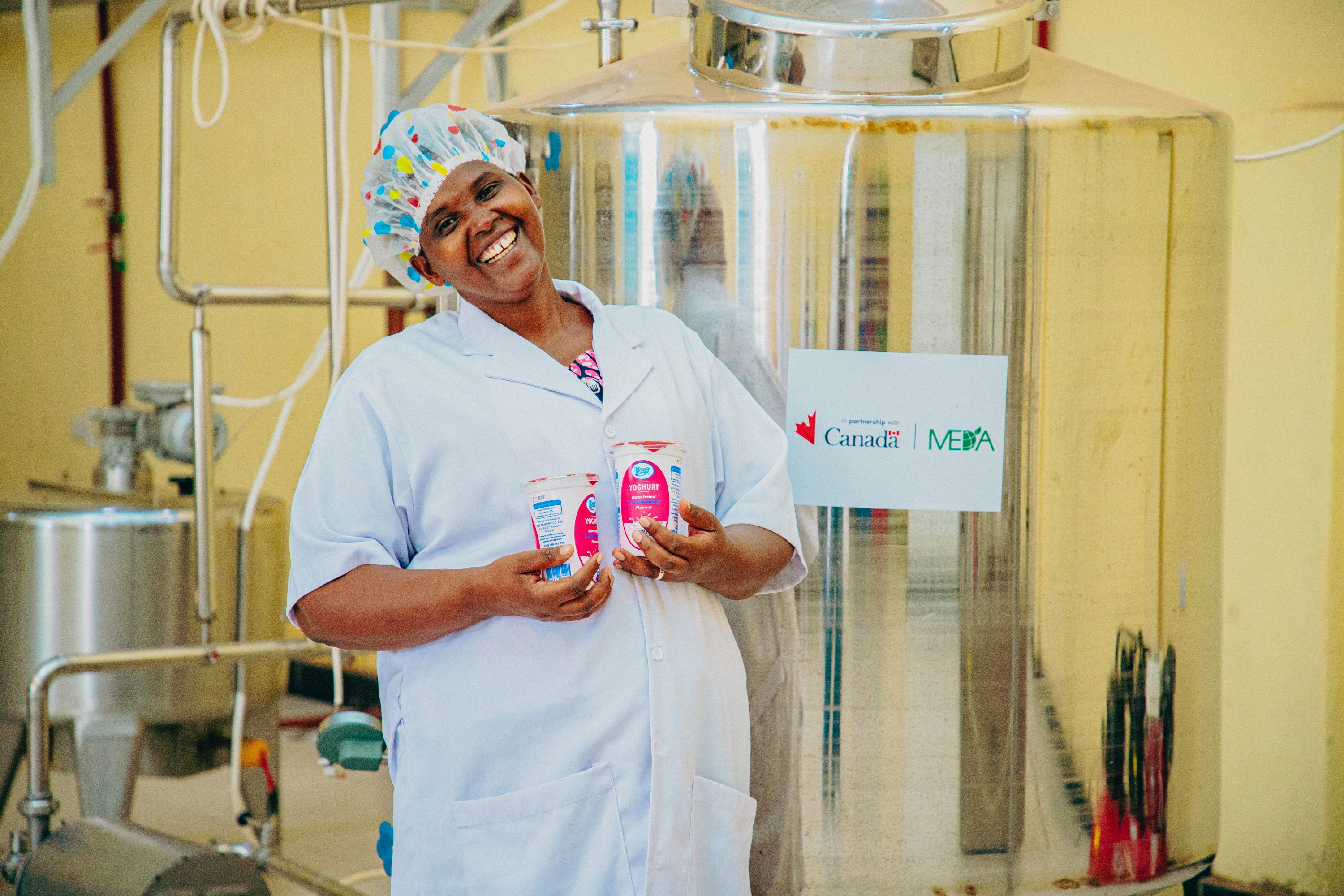 woman in factory holds dairy products